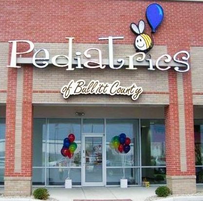 A brick building with a sign that says pediatrics of ballitt county