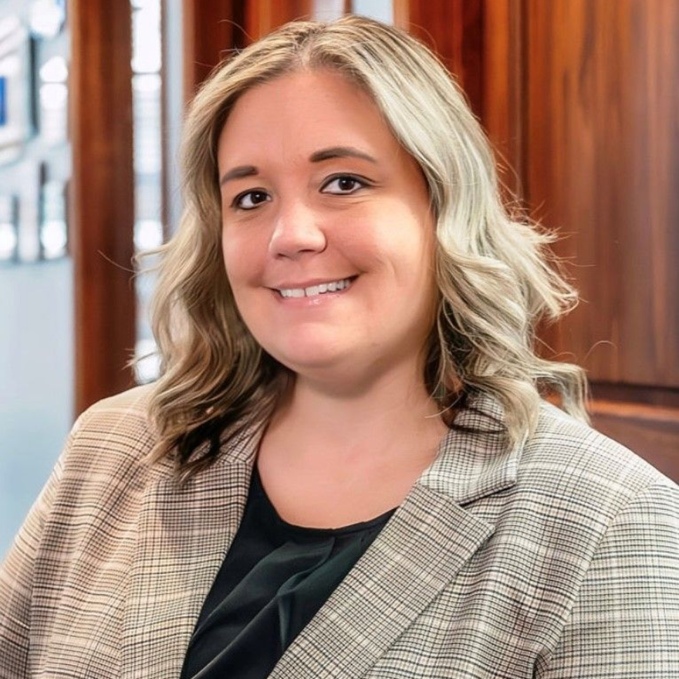 A man in a suit and tie is smiling for the camera