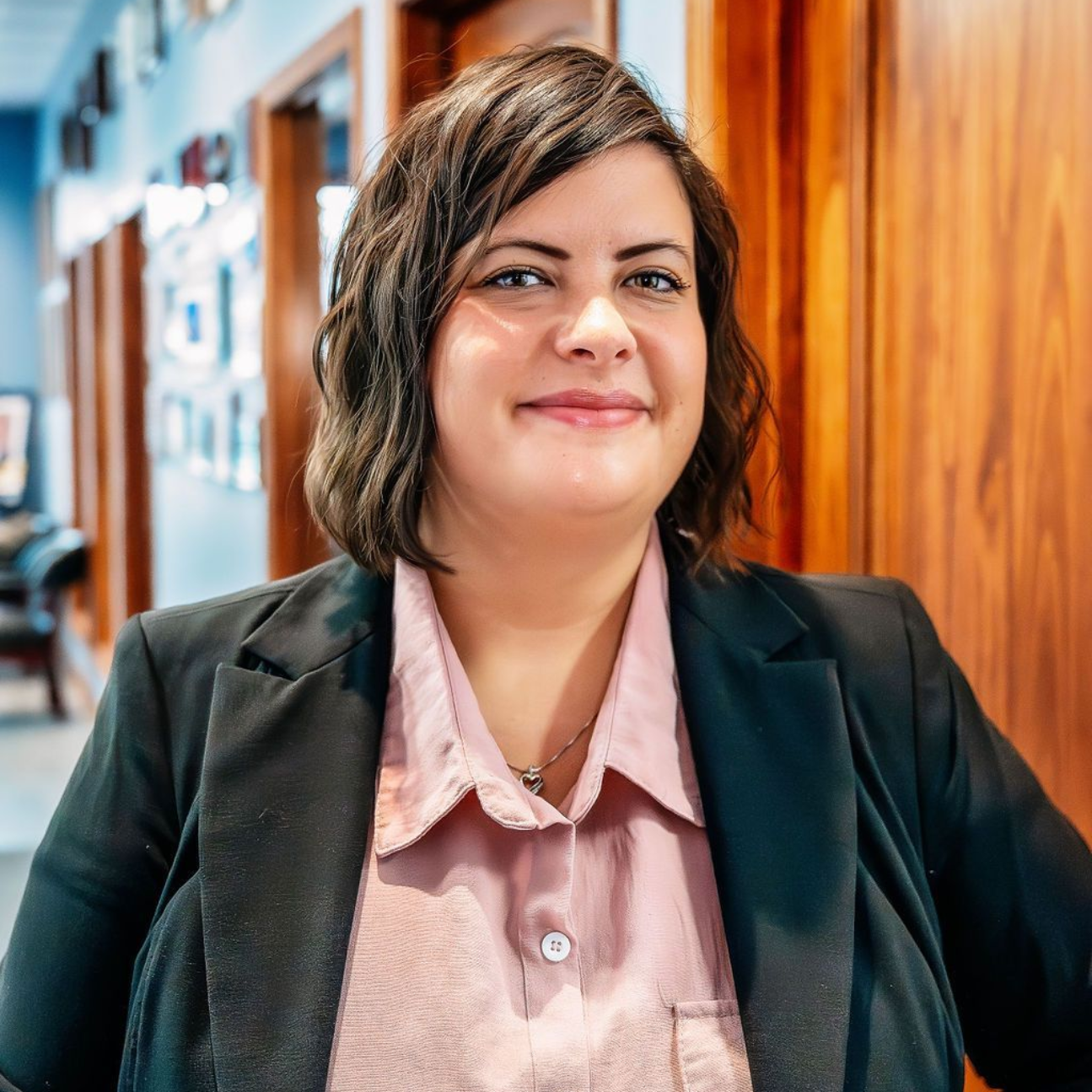 A man in a suit and tie is smiling for the camera