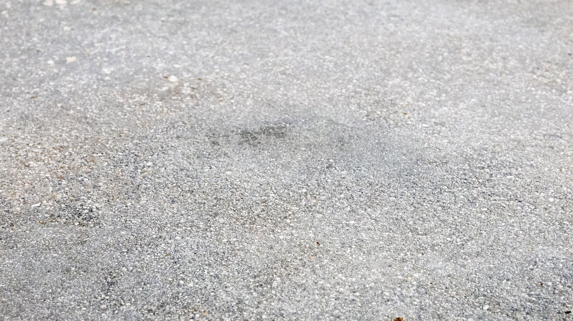 A smooth and level concrete substrate flooring in a residential garage.