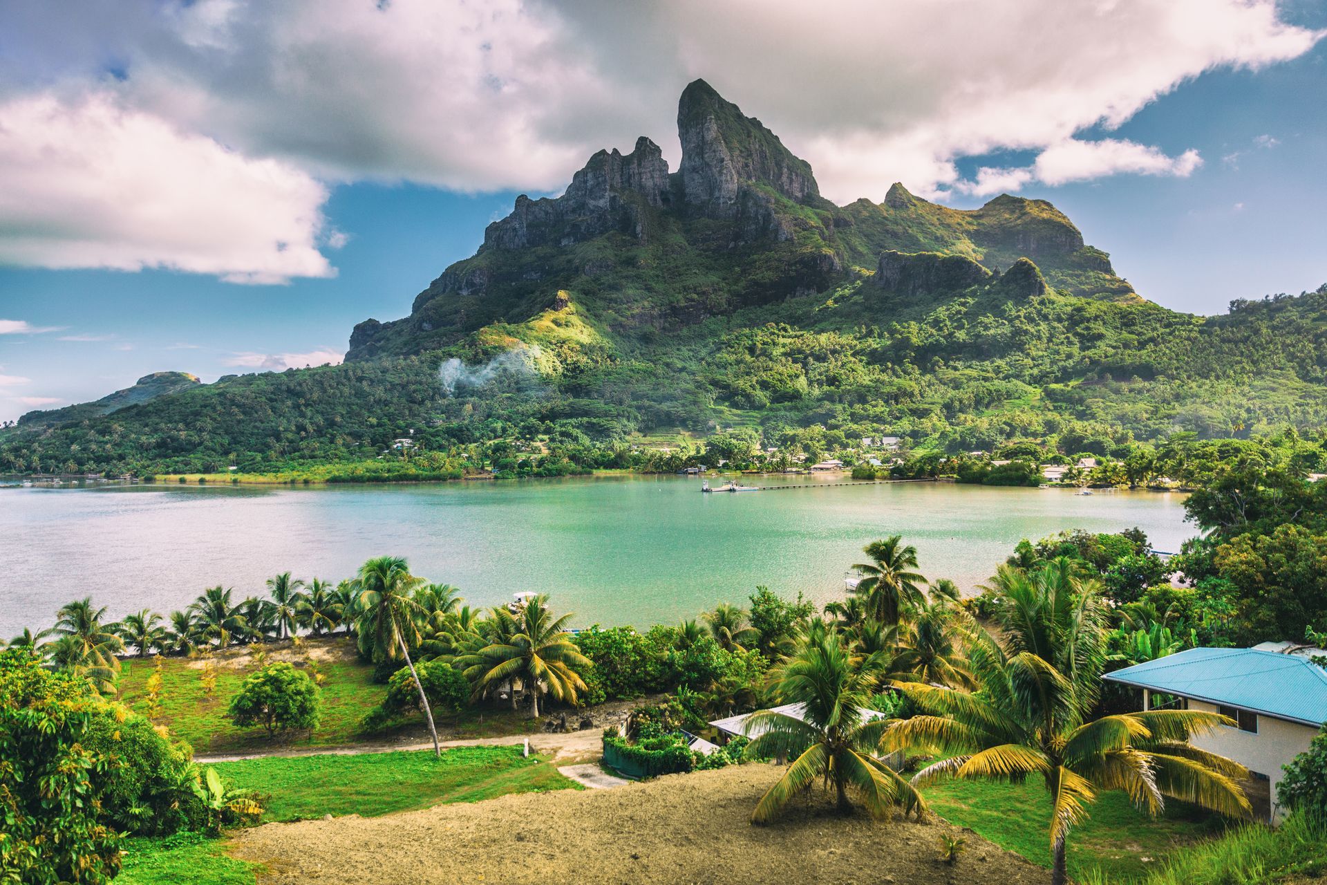 There is a mountain in the background and a body of water in the foreground.