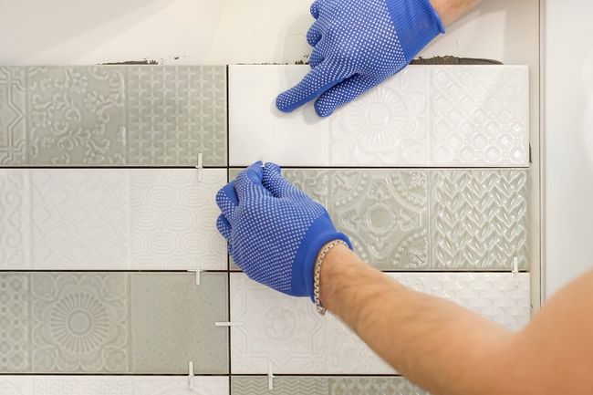 man installing a tile