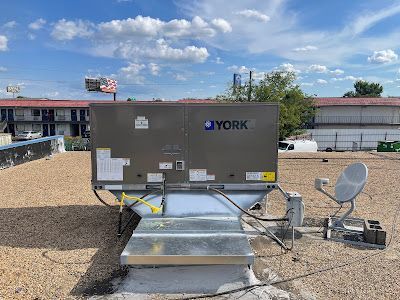 A york air conditioner is sitting on top of a roof.