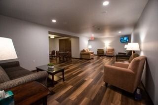 A living room filled with furniture and a television.