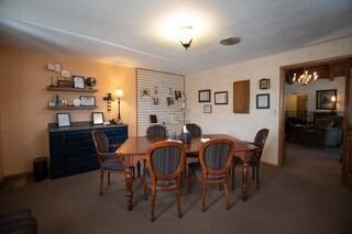 A dining room with a table and chairs in it.