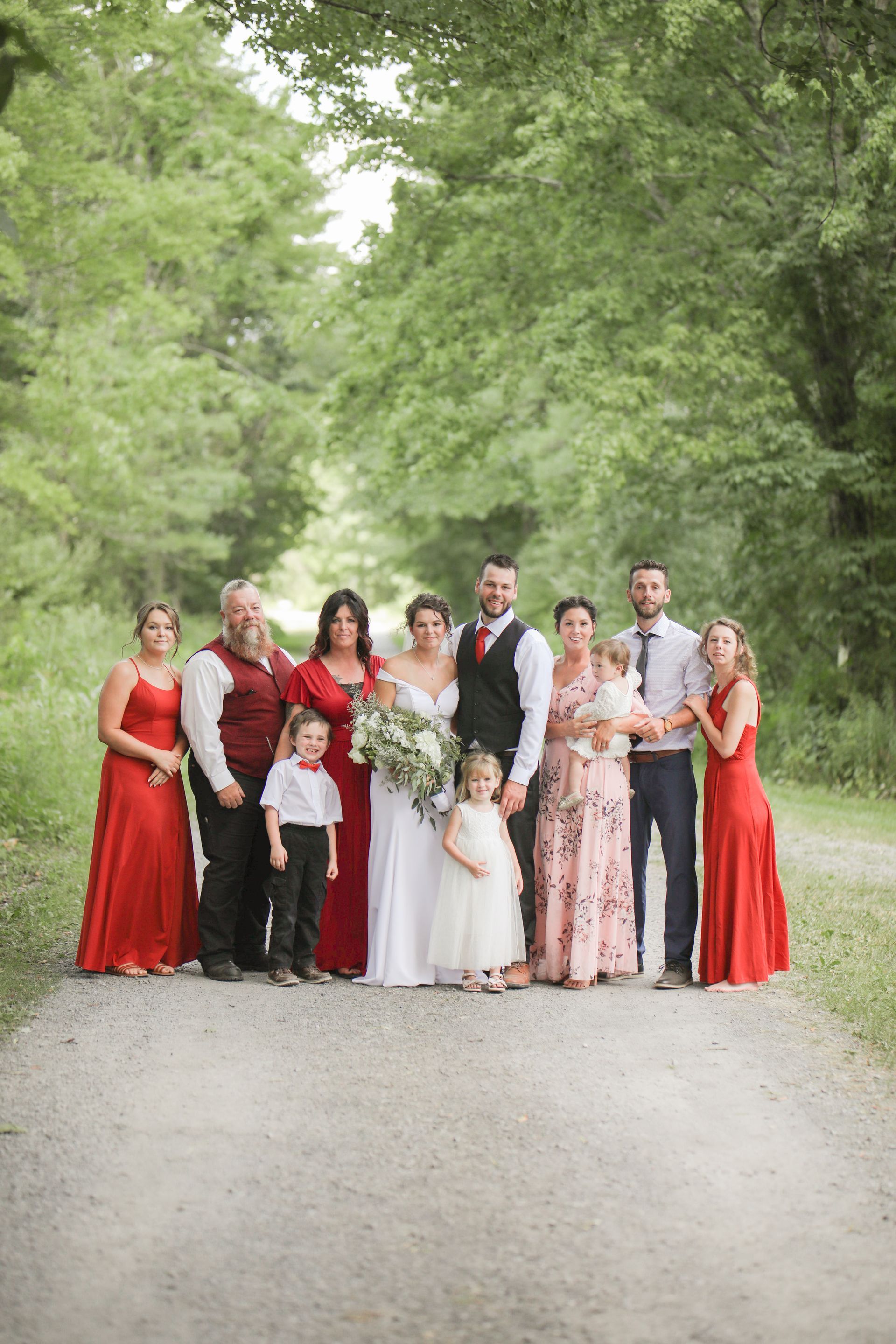 A bride and groom are posing for a picture with their wedding party.