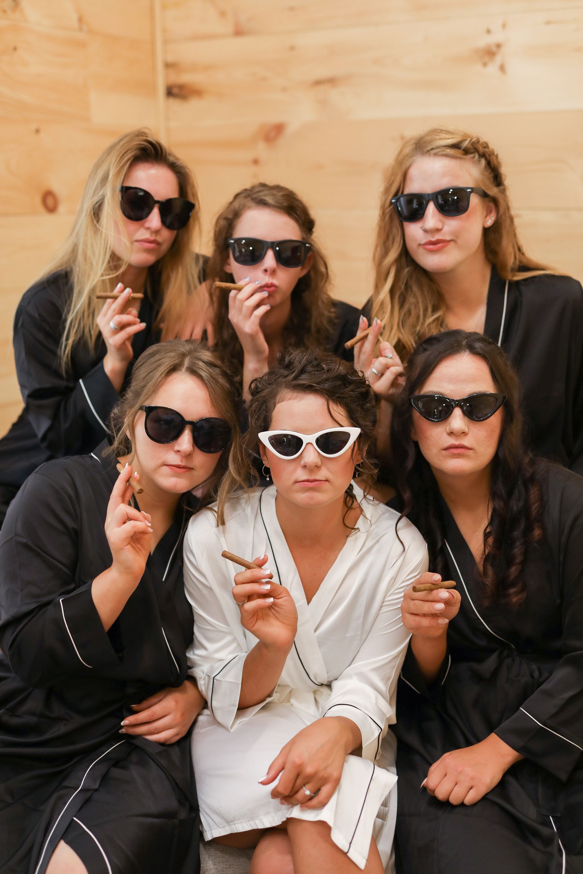 bridesmaids posing for a photo wearing sunglasses