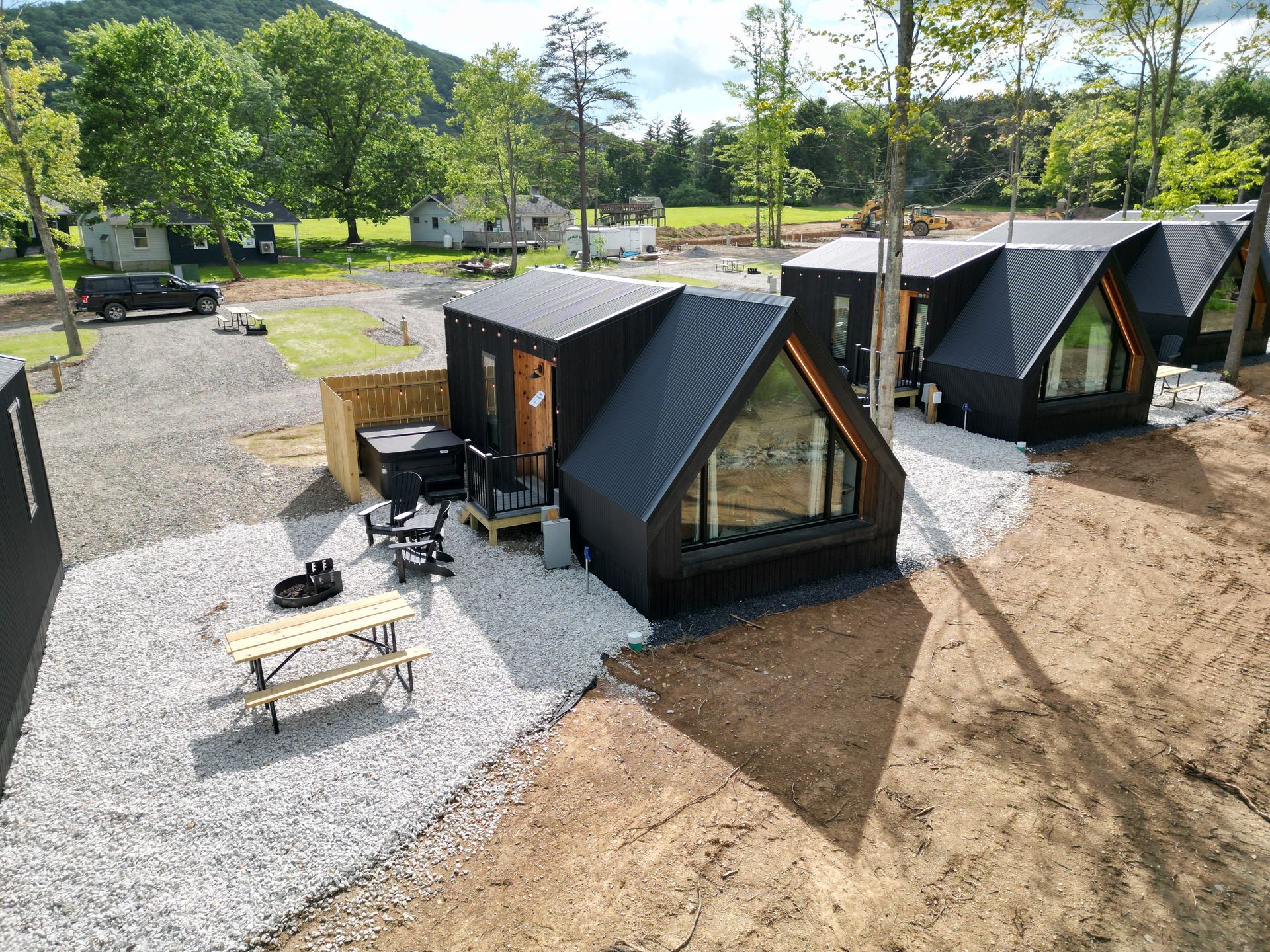 An aerial view of a row of small houses with a picnic table in front of them.