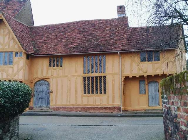 A traditional Ochre limewashed timber framed building in Lavenham Suffolk.