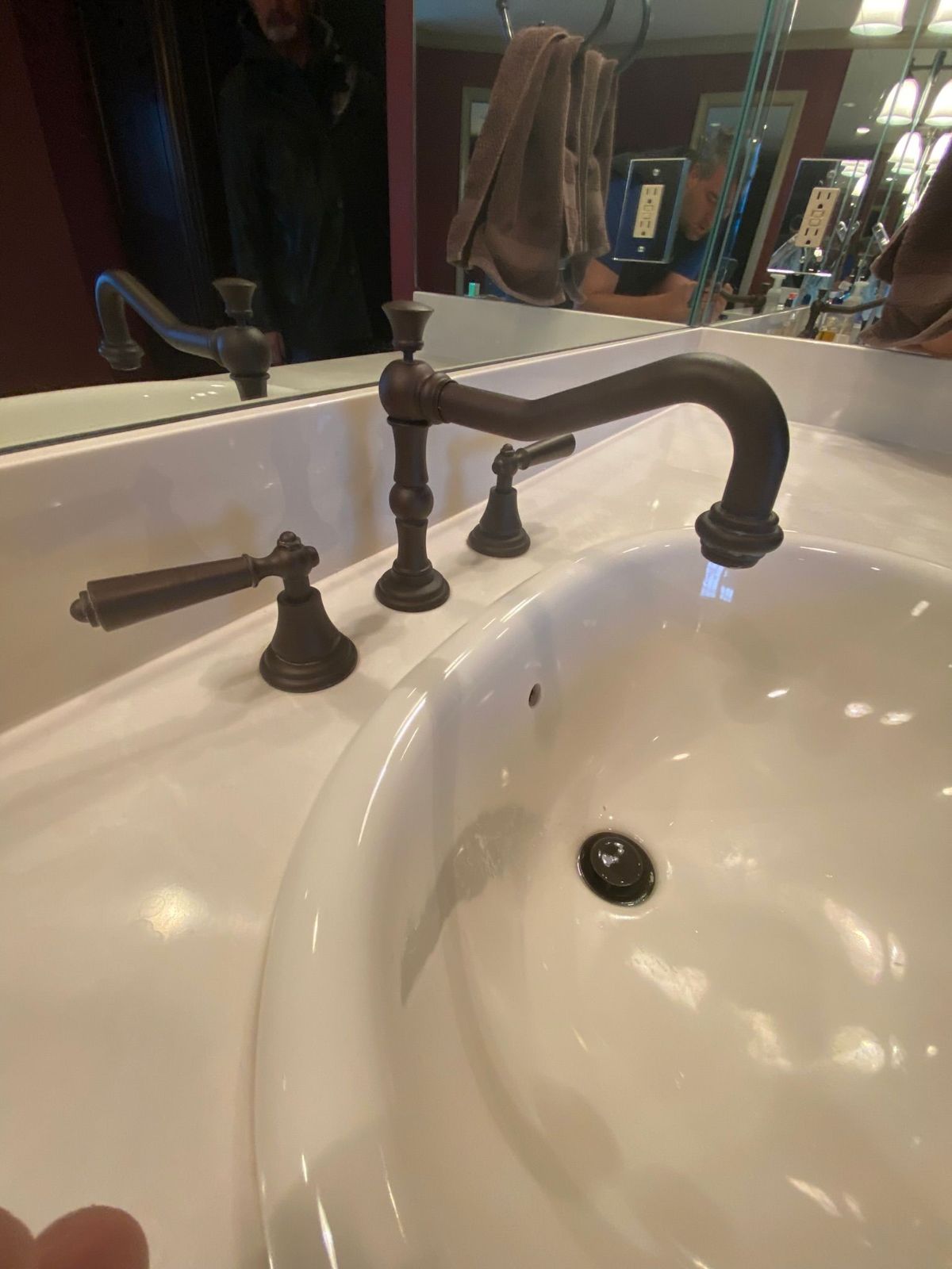 A bathroom sink with a faucet and a mirror.