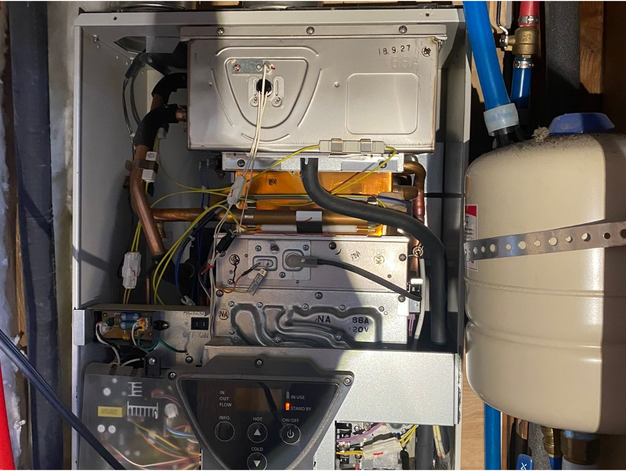 The inside of a boiler with a hose coming out of it.