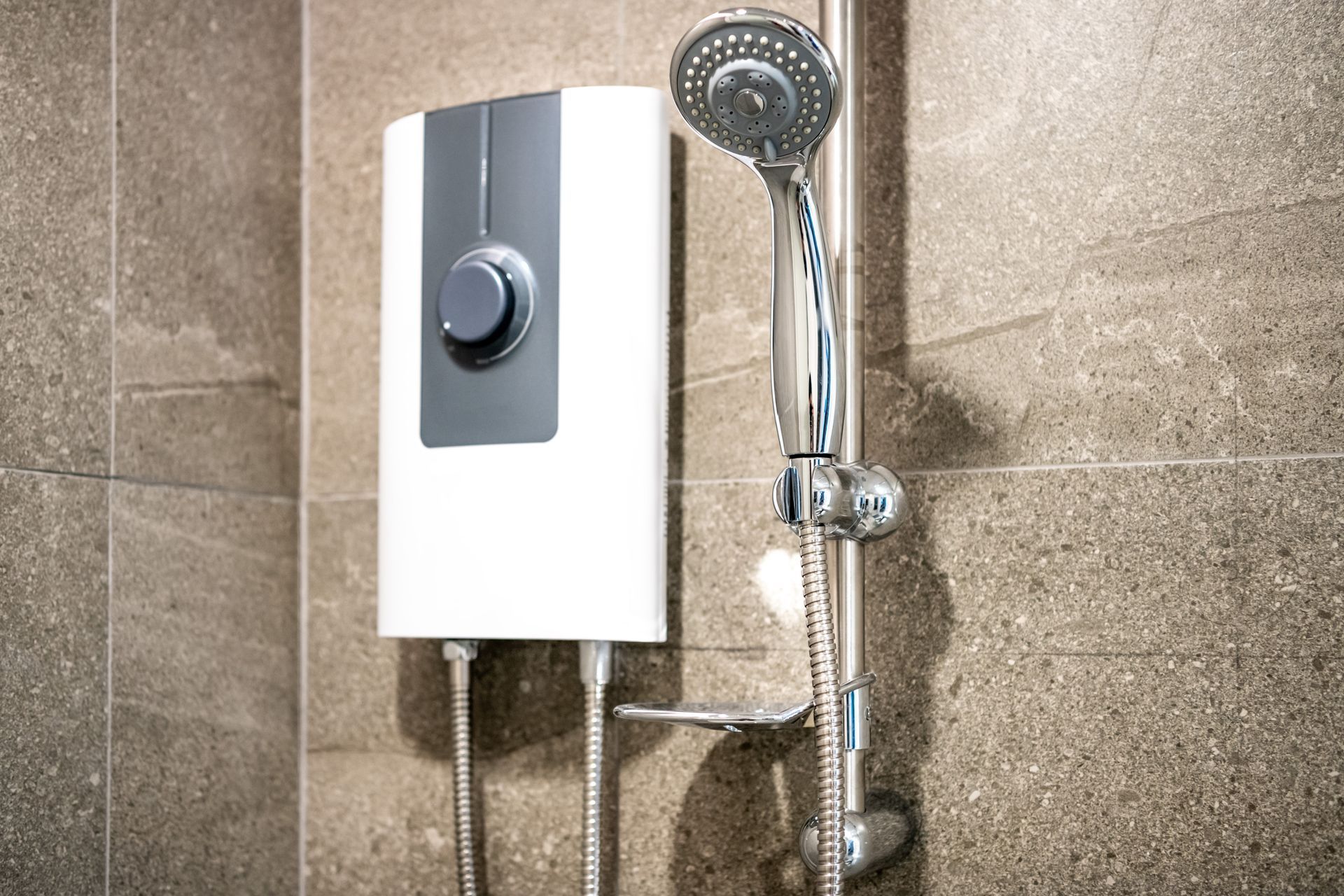 A shower head is attached to a wall in a bathroom.