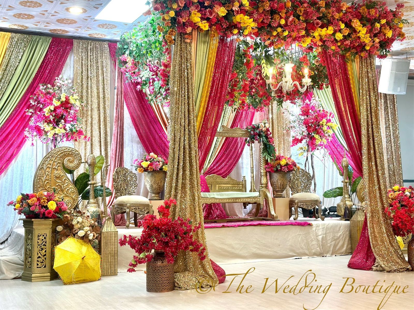 Punjabi Sikh wedding decor featuring colorful drapes and decorations on a reception stage