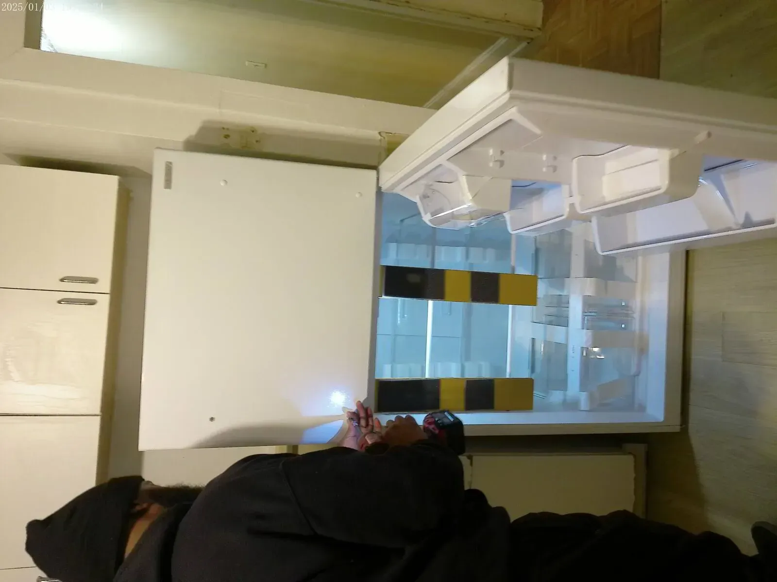 Appliance installation and handyman service inspecting newly delivered refrigerator