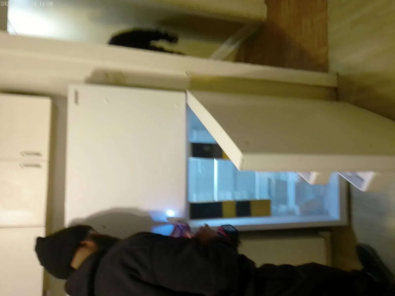 Handyman performing refrigerator installation during kitchen update