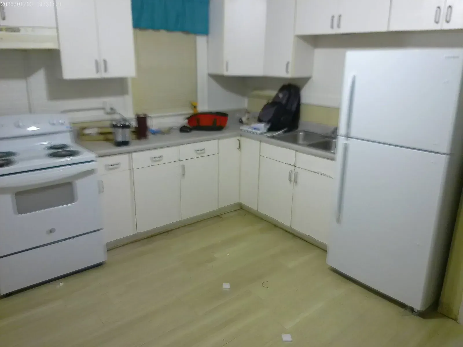 Kitchen renovation with updated cabinets, vinyl plank flooring, and appliance installation by BRC Contracting Inc.