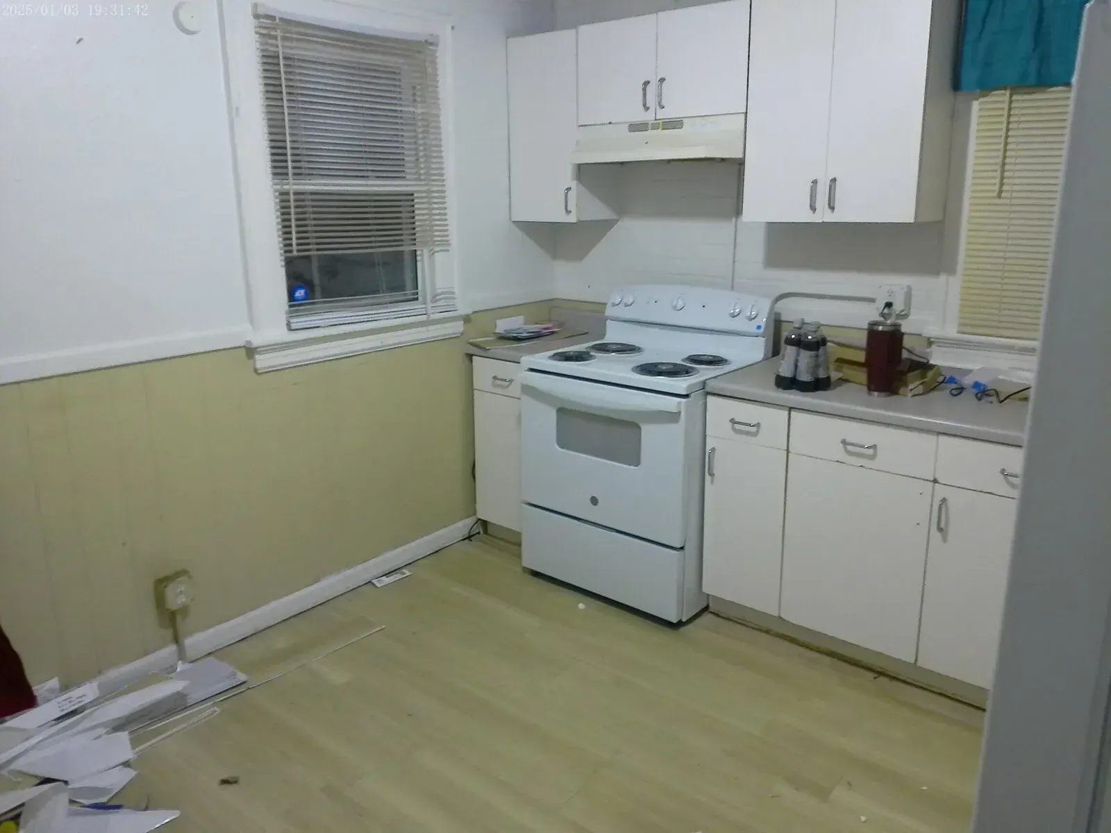 Kitchen remodel showing new vinyl plank flooring and cabinet prep work