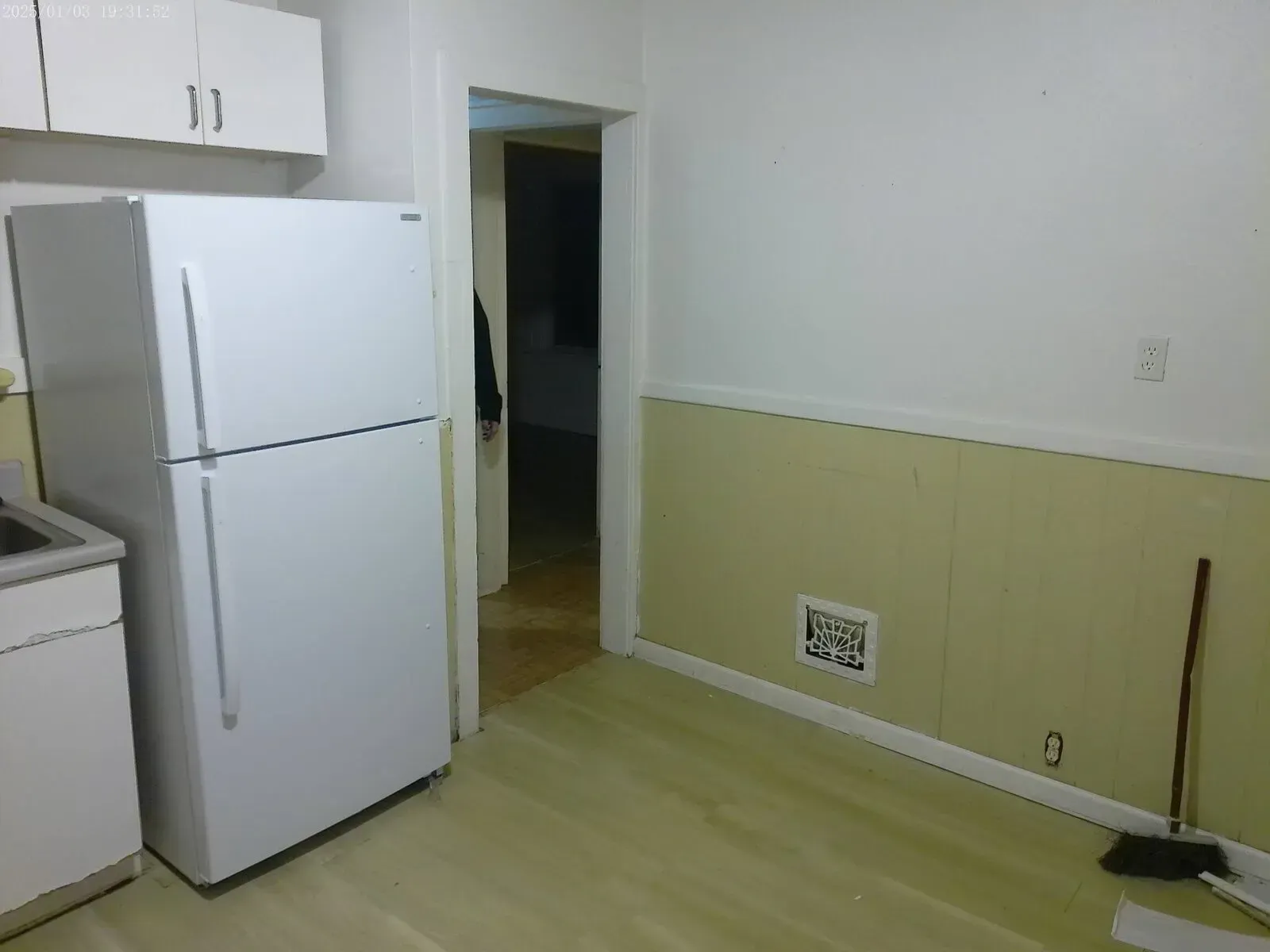 Handyman service installing new flooring and prepping wall for trim and paint
