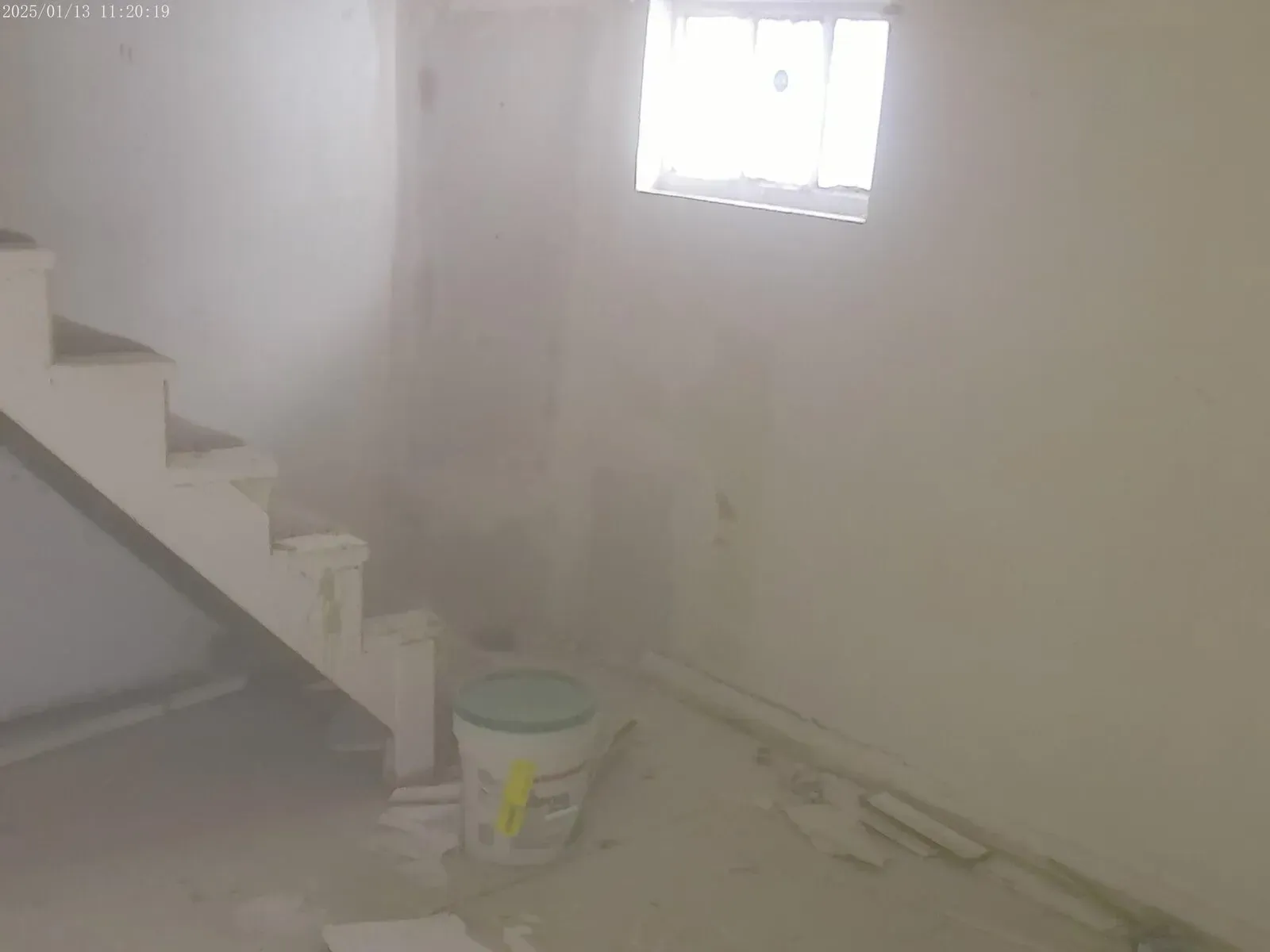 Interior drywall installation near basement stairs during renovation project