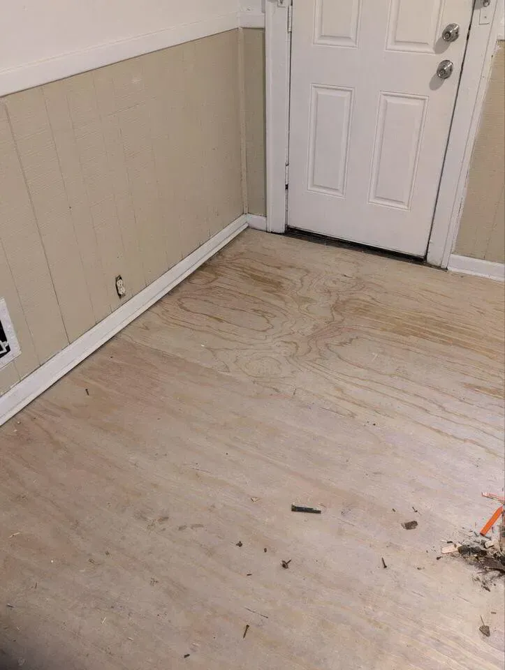 Subfloor installation in entryway prior to new flooring and door trim