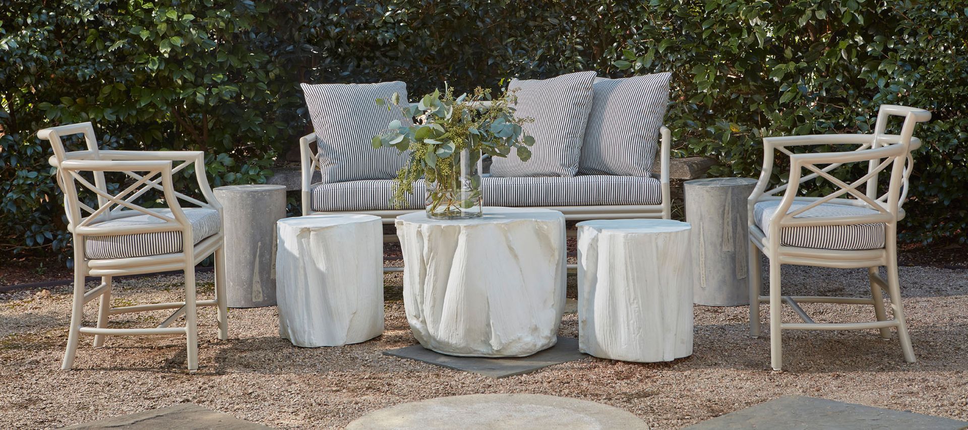 A couch and chairs are sitting on top of a pile of gravel.