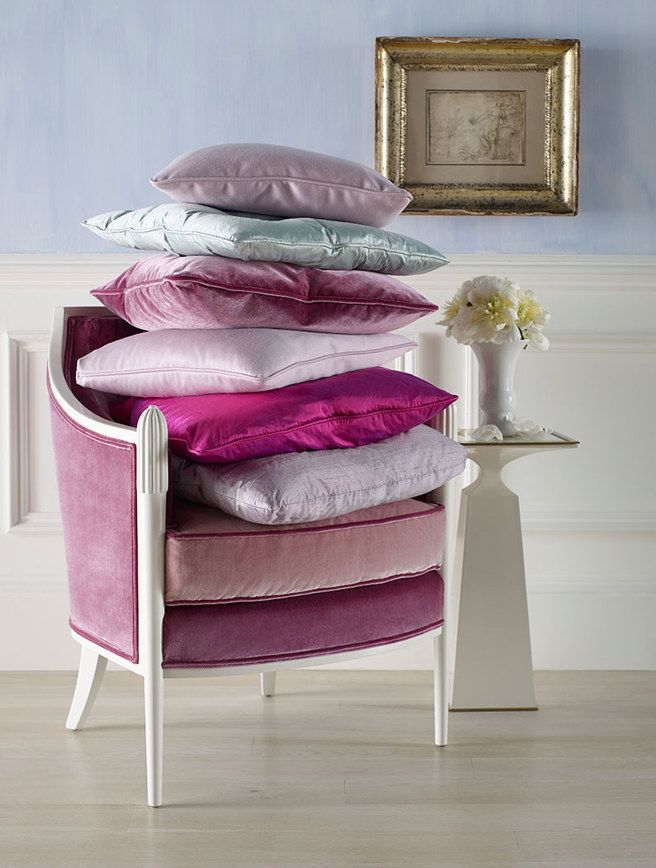 A chair with a stack of pillows on top of it