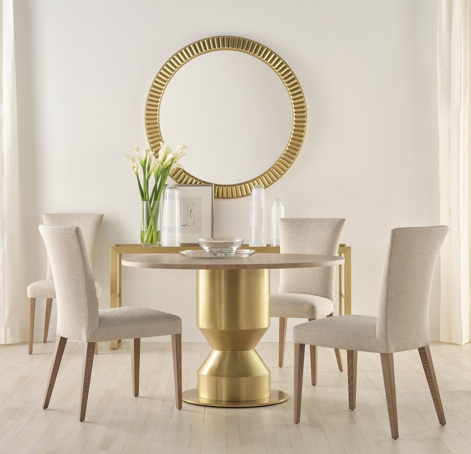 A dining room with a table and chairs and a mirror