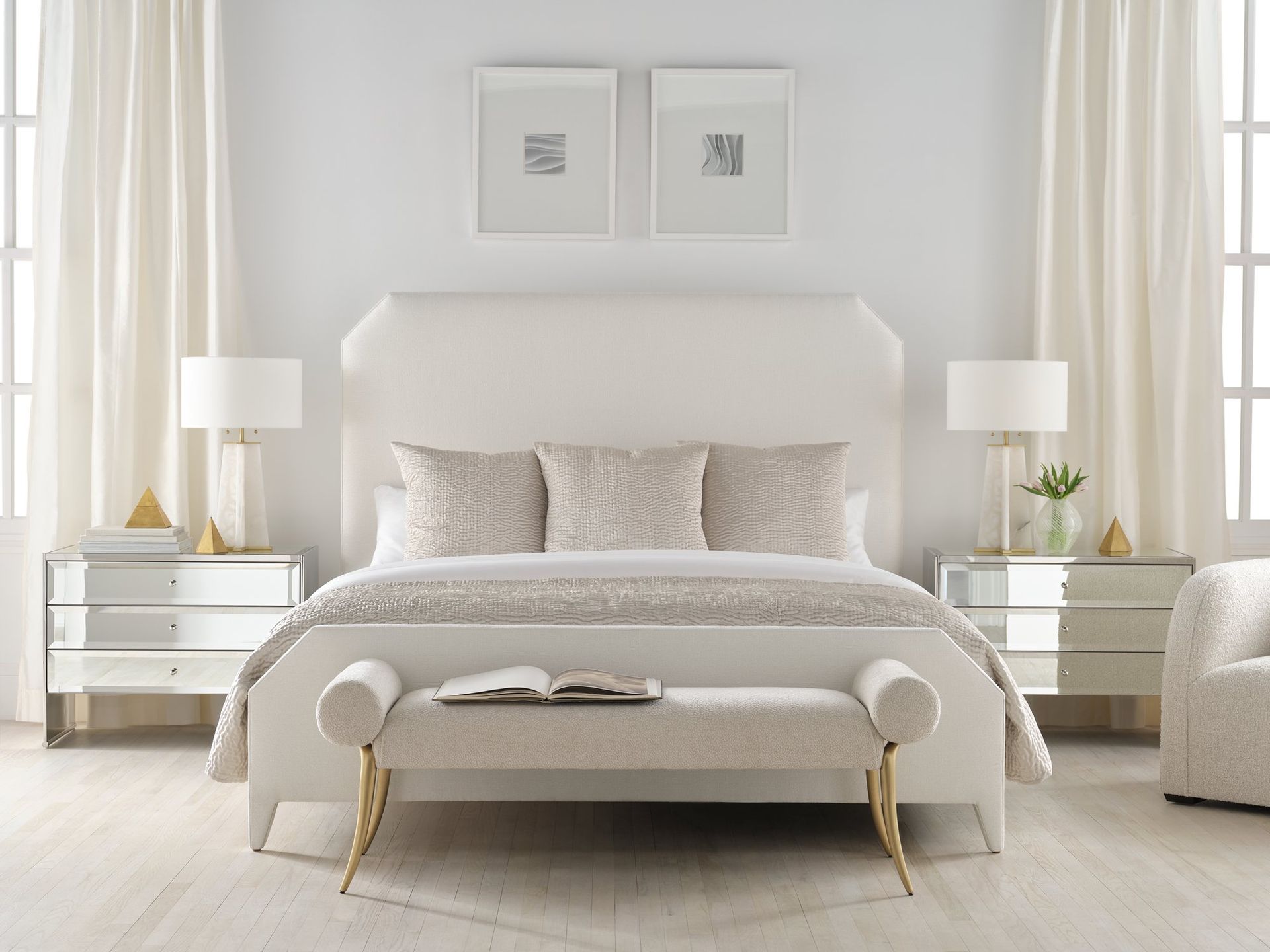 A bedroom with a bed , nightstands , lamps and a bench.