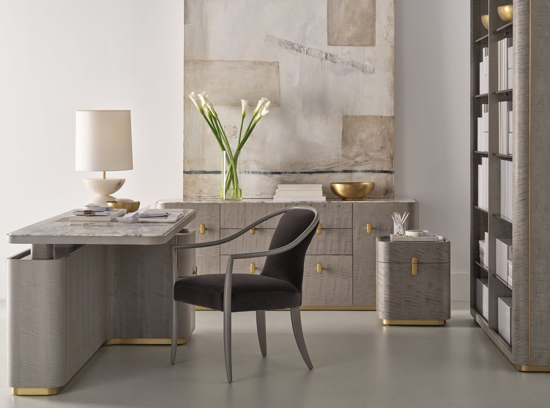 There is a desk with a chair and a lamp in the room.