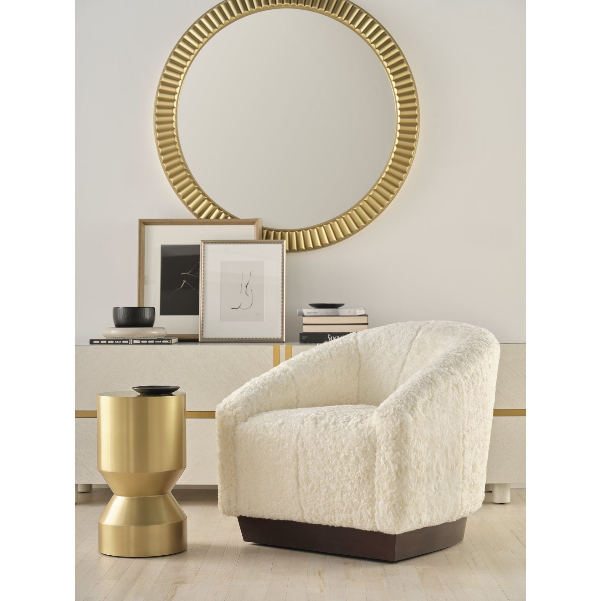 A white chair is sitting in front of a round mirror.