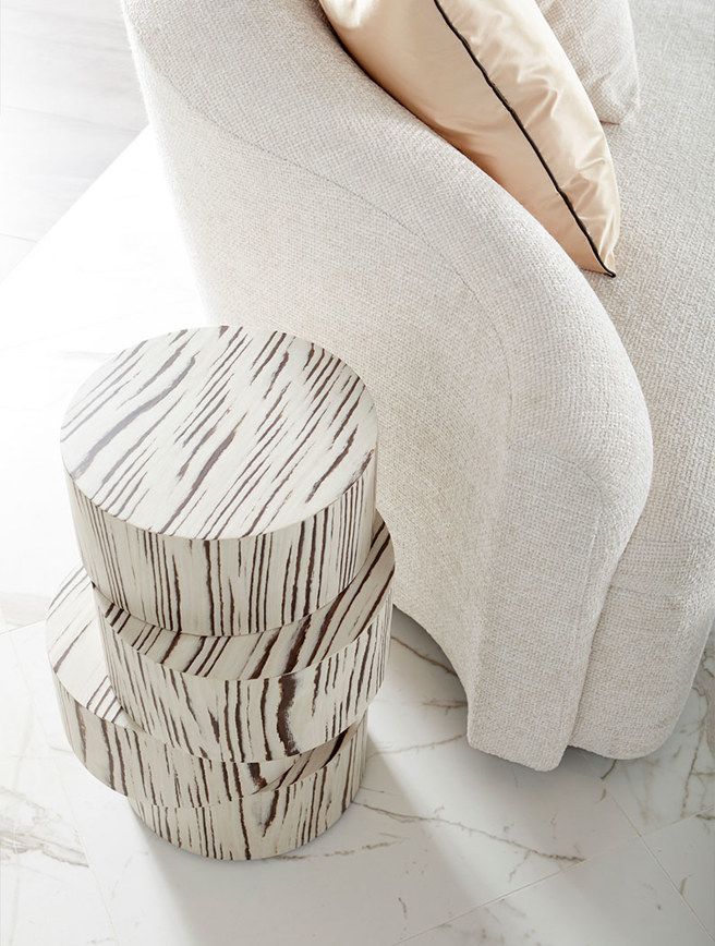 A white chair with a zebra print table in front of it