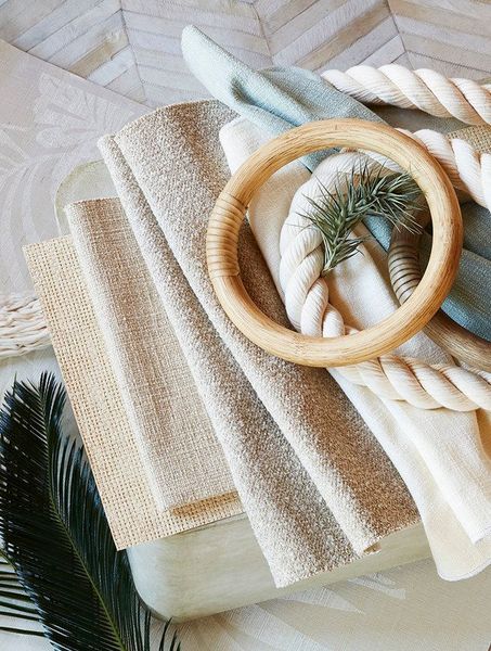 A wooden napkin ring is sitting on top of a pile of napkins.