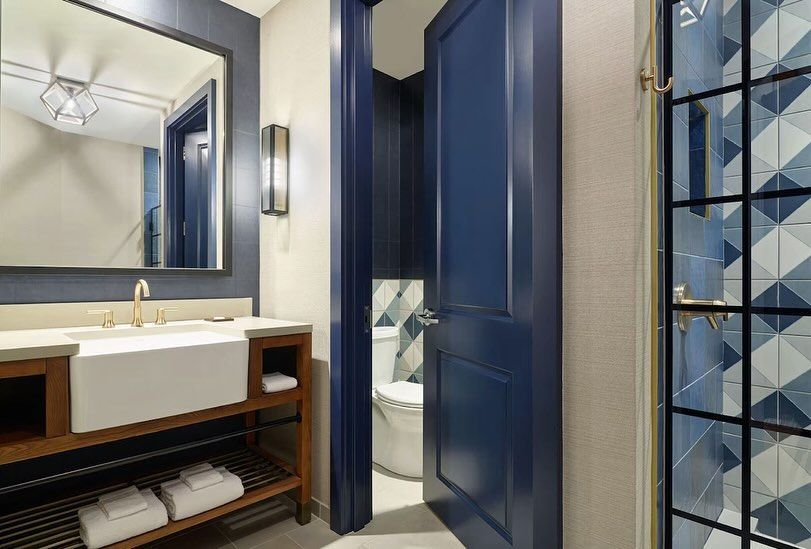 A bathroom with a sink , toilet , and mirror.