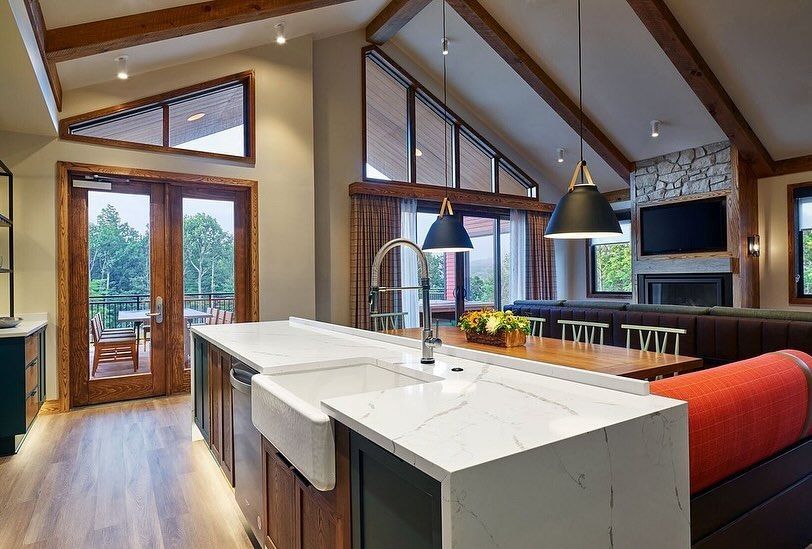 A kitchen in a house with a large island and a sink.