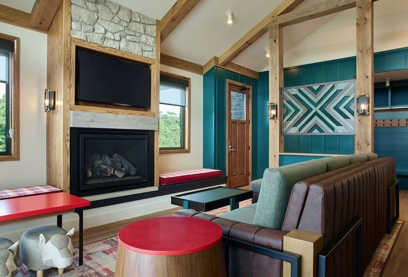 A living room with a fireplace , couch , table and television.