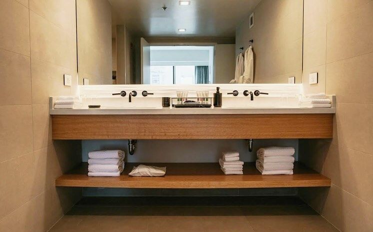 A bathroom with two sinks and a large mirror.