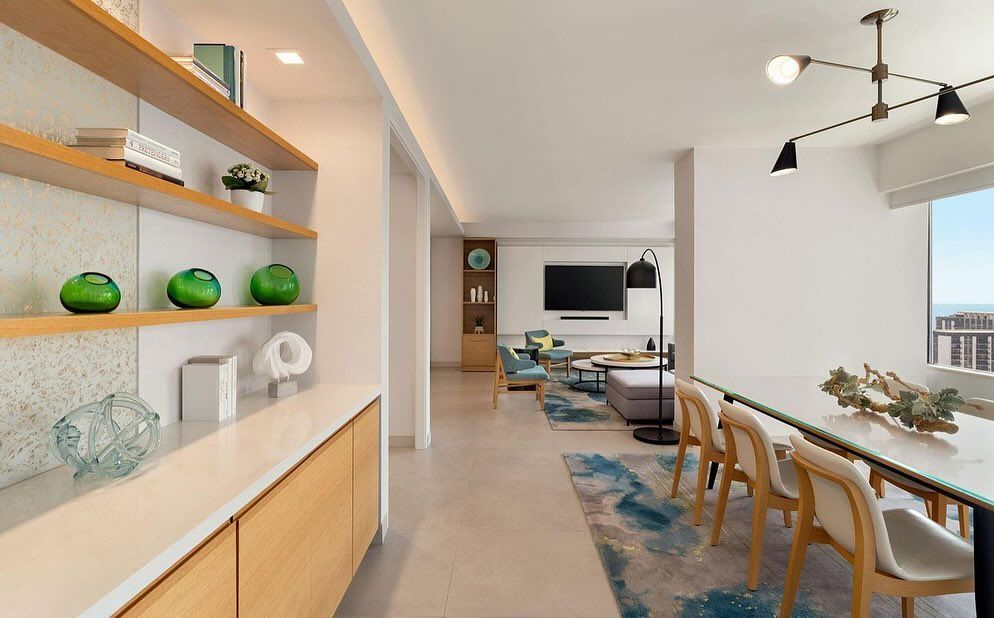 A living room with a dining table and chairs and a television.
