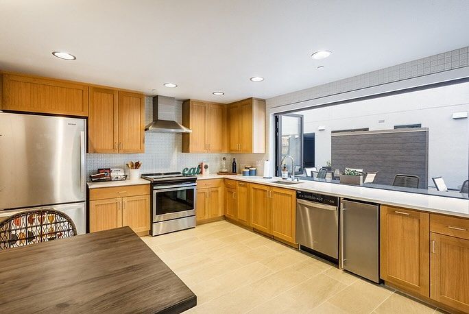 A kitchen with stainless steel appliances and wooden cabinets