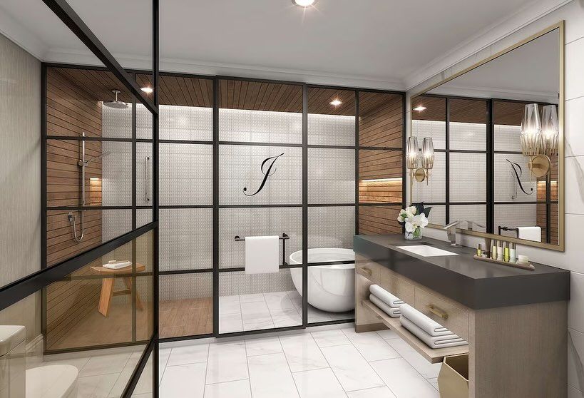 A bathroom with a tub , sink , mirror and shower.