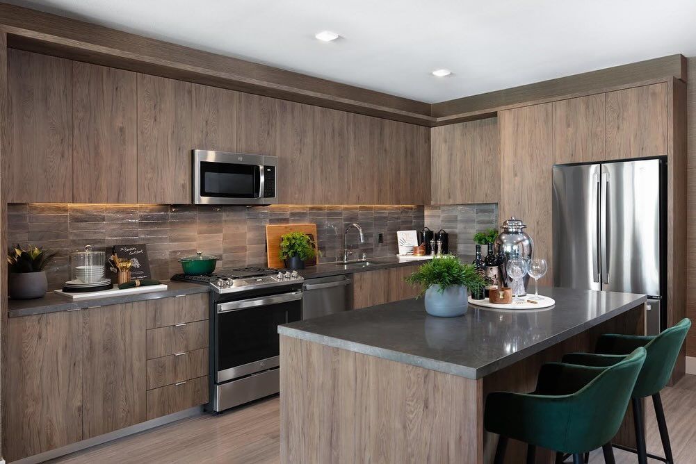 A kitchen with wooden cabinets and stainless steel appliances.