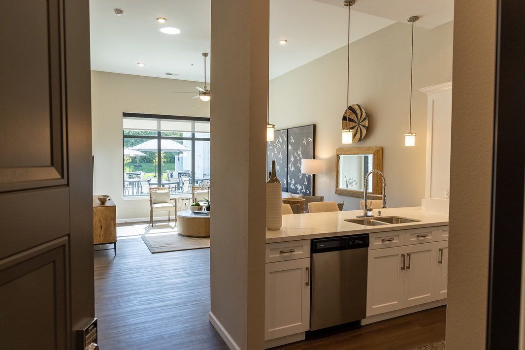 A kitchen with white cabinets and a stainless steel dishwasher.