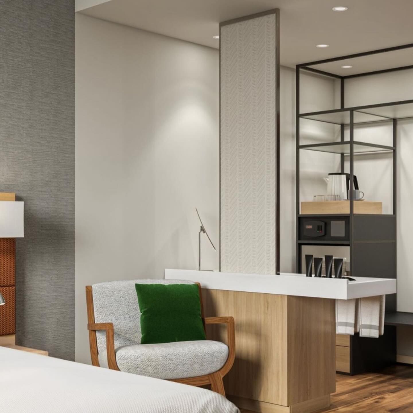 A hotel room with a green pillow on a chair