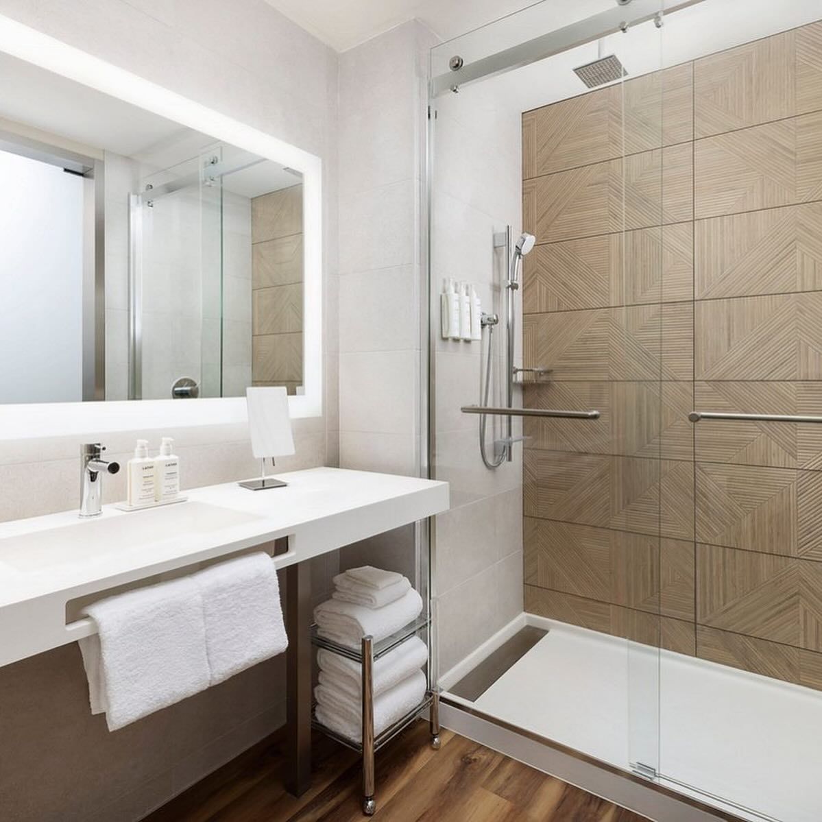 A bathroom with a sink and a walk in shower