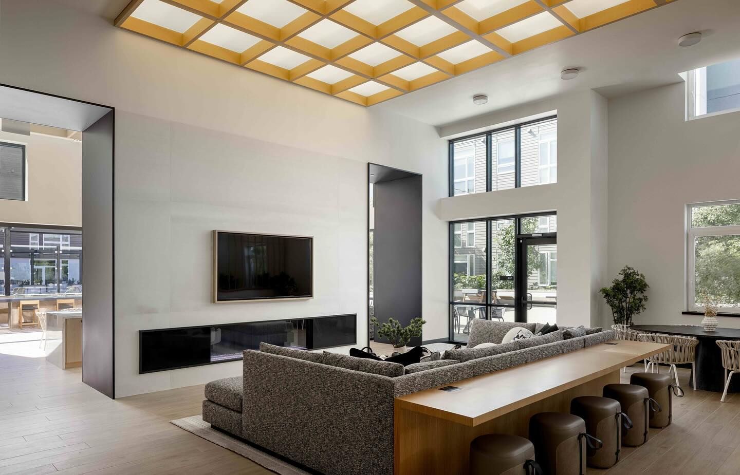 A living room with a couch and a television on the wall.