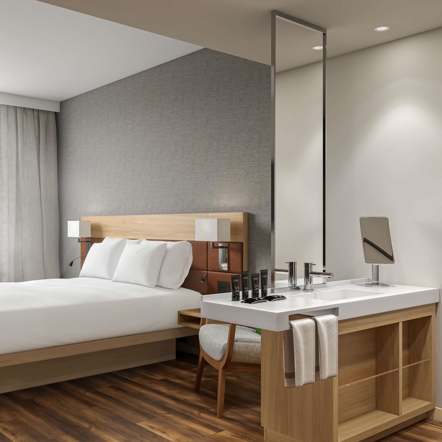 A hotel room with a large bed and a sink