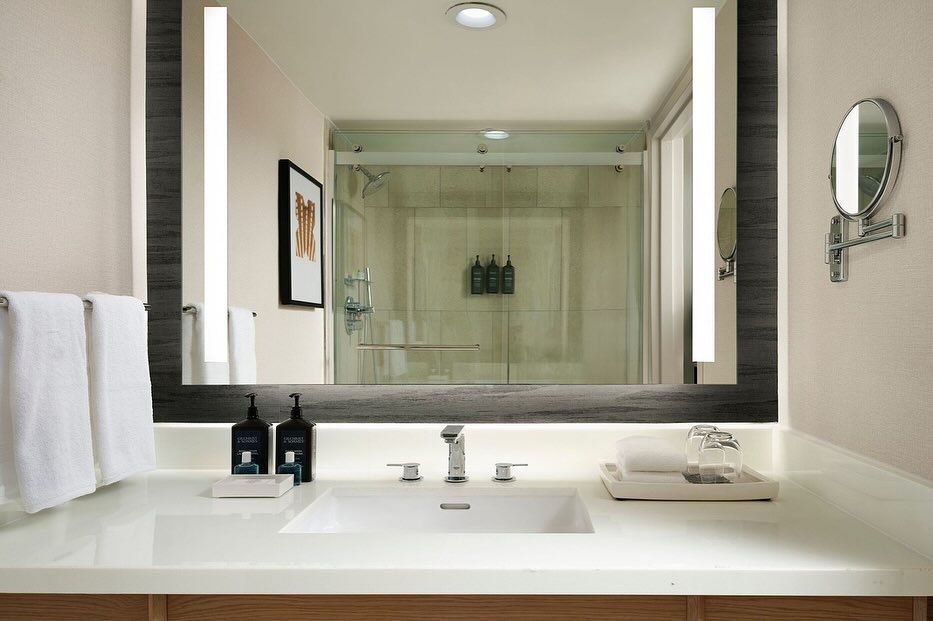 A bathroom with a sink and a large mirror