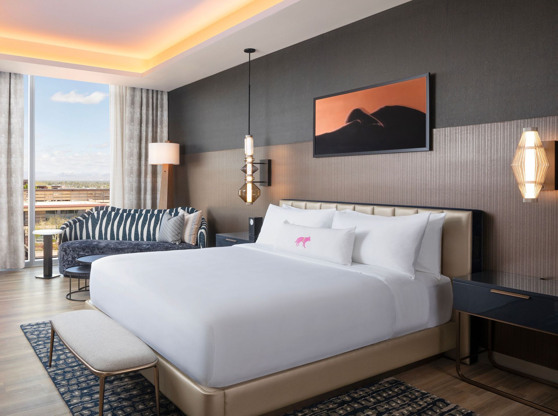 A hotel room with a large bed and a couch