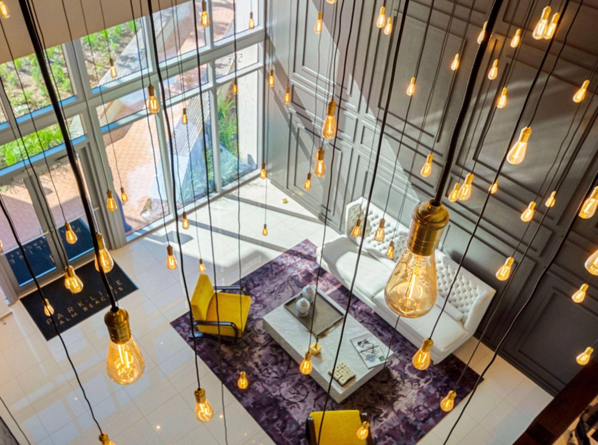 An aerial view of a living room with lots of lights hanging from the ceiling.
