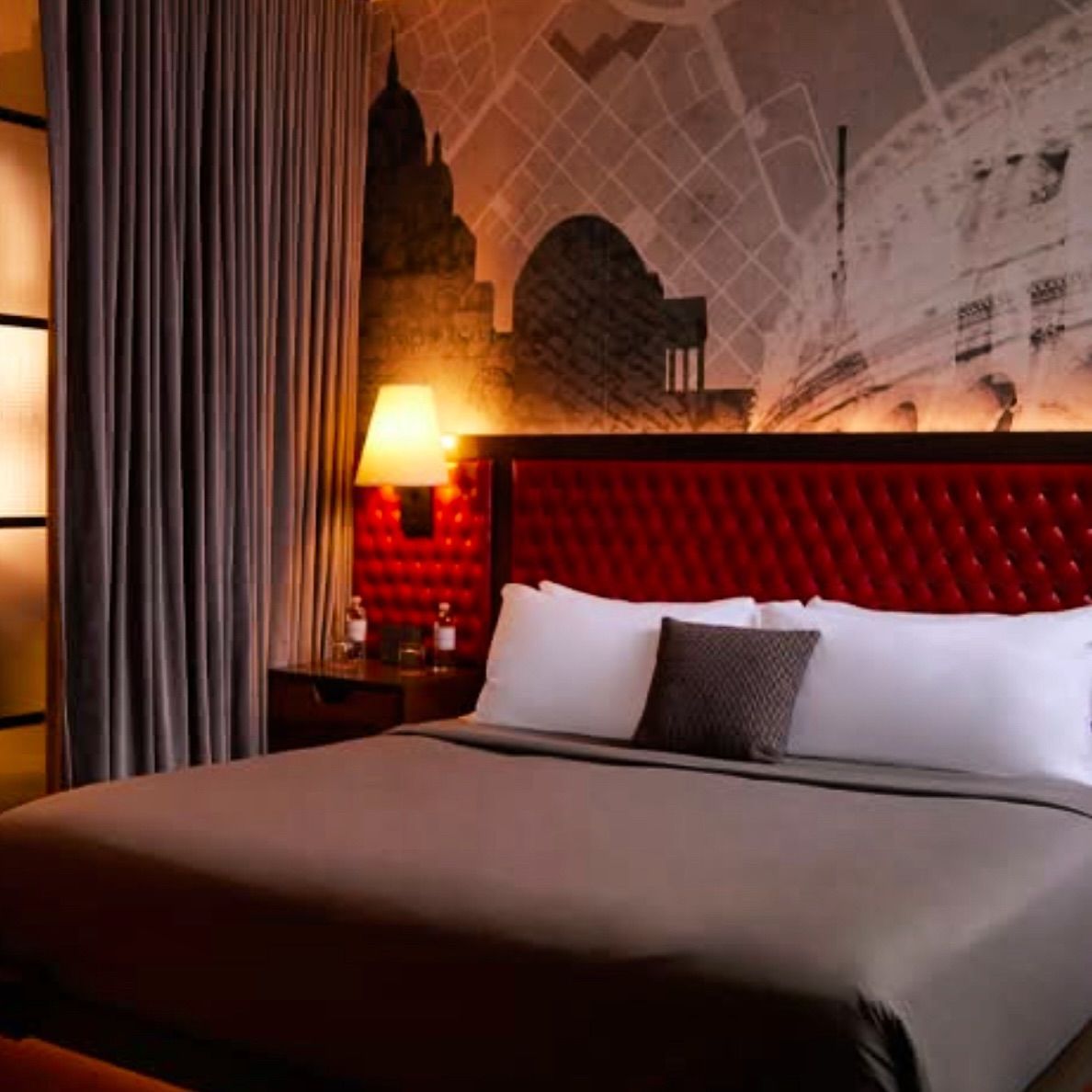 A hotel room with a large bed and a map on the wall