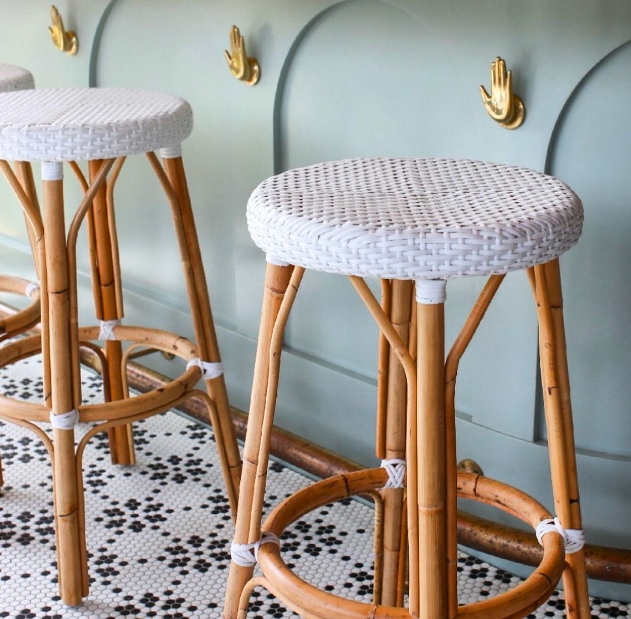Two wicker bar stools are sitting next to each other
